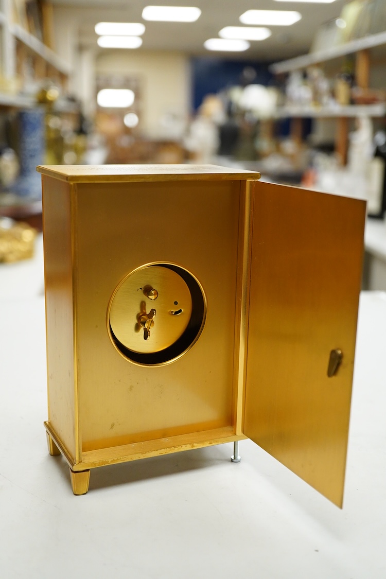 A Jaeger LeCoultre timepiece in the form of a wardrobe with pierced doors, one leg missing, 16cm high